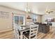 A dining table adjacent to a living space featuring a couch and television at 567 Jewel St, Brighton, CO 80603