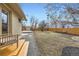 Expansive backyard with a well-maintained lawn, gravel path, shed, and a wooden deck at 51 S Eaton St, Lakewood, CO 80226