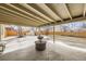 Inviting covered patio with a textured concrete pad, perfect for outdoor relaxation and entertaining at 51 S Eaton St, Lakewood, CO 80226