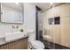 Stylish bathroom featuring modern fixtures, a glass-enclosed shower, and textured walls at 51 S Eaton St, Lakewood, CO 80226