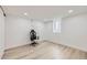 Minimalist bedroom with a sleek black and white gaming chair and modern lighting at 51 S Eaton St, Lakewood, CO 80226