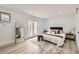 Bright bedroom featuring a bed, full-length mirror, and a door leading outside at 51 S Eaton St, Lakewood, CO 80226