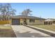 Ranch-style home with a brick facade, wood accents, and a well-maintained front yard at 51 S Eaton St, Lakewood, CO 80226