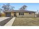 Ranch-style home with a brick facade, wood accents, and a well-maintained front yard at 51 S Eaton St, Lakewood, CO 80226