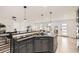 Kitchen island with granite countertops and gas stovetop, open to the living room at 51 S Eaton St, Lakewood, CO 80226