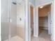 Modern bathroom featuring a glass-enclosed shower and access to the toilet and walk-in closet at 15443 W 65Th Ave # B, Arvada, CO 80007