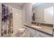 Bright bathroom featuring a neutral color scheme, sleek vanity, and shower with decorative curtain at 15443 W 65Th Ave # B, Arvada, CO 80007