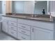 Stylish bathroom vanity featuring double sinks, white cabinetry, and modern hardware at 15443 W 65Th Ave # B, Arvada, CO 80007