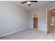 Comfortable bedroom with neutral walls, carpeted floors, a ceiling fan, and closet access at 15443 W 65Th Ave # B, Arvada, CO 80007