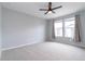 Bright bedroom with neutral walls, carpeted floors, and natural light from the large windows at 15443 W 65Th Ave # B, Arvada, CO 80007
