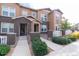 Beautiful townhome with manicured lawn and charming brick accents near the front entrance at 15443 W 65Th Ave # B, Arvada, CO 80007