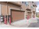 Exterior view of garages featuring brown doors at 15443 W 65Th Ave # B, Arvada, CO 80007