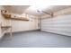 Bright garage space with shelving for storage and painted floor at 15443 W 65Th Ave # B, Arvada, CO 80007