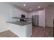 Modern kitchen boasts white cabinets, stainless steel appliances, and a gray countertop island at 15443 W 65Th Ave # B, Arvada, CO 80007