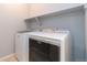Convenient laundry room equipped with modern, front-loading washer and dryer units at 15443 W 65Th Ave # B, Arvada, CO 80007