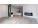 Bright, open-concept living space with modern fireplace, light floors, and stylish kitchen view at 15443 W 65Th Ave # B, Arvada, CO 80007