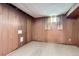 This basement area has wood paneling and a small window at 5370 S Sherman St, Littleton, CO 80121