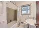 Bathroom featuring a tub/shower combo, stylish tilework, and natural light at 5370 S Sherman St, Littleton, CO 80121