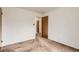 This bedroom features a neutral color scheme and a wood door at 5370 S Sherman St, Littleton, CO 80121