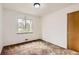 This bedroom has a neutral color palette, one window and a wood door at 5370 S Sherman St, Littleton, CO 80121