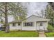 Charming one-story home with green trim, grassy lawn, and a sidewalk leading to the front door at 5370 S Sherman St, Littleton, CO 80121