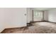 Bright living room featuring a large window for plenty of natural light and neutral carpet at 5370 S Sherman St, Littleton, CO 80121