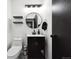 Chic bathroom featuring modern fixtures, a stylish mirror, decorative shelves, and sleek black accents at 20765 E 39Th Ave, Denver, CO 80249