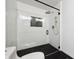 Modern bathroom with a glass walk-in shower, sleek black hardware and herringbone tile at 20765 E 39Th Ave, Denver, CO 80249