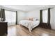 Inviting bedroom featuring natural light, minimalist decor, and hardwood floors at 20765 E 39Th Ave, Denver, CO 80249
