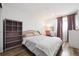 Cozy bedroom featuring a comfortable bed, ample natural light, a desk with chair, and built-in storage at 20765 E 39Th Ave, Denver, CO 80249