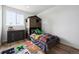 bedroom with a bunk bed, decorative rug, and a dresser for organized storage at 20765 E 39Th Ave, Denver, CO 80249