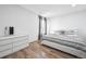 Bright bedroom featuring a contemporary bed, a modern dresser, and abundant natural light through sheer curtains at 20765 E 39Th Ave, Denver, CO 80249