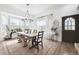 Bright dining room featuring a chandelier, large windows, and modern decor at 20765 E 39Th Ave, Denver, CO 80249