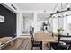Bright dining room with a modern chandelier, and views of the updated kitchen and staircase at 20765 E 39Th Ave, Denver, CO 80249