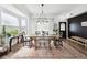 Bright dining room featuring a chandelier, large windows, and modern decor at 20765 E 39Th Ave, Denver, CO 80249