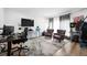 Living room featuring a TV, two club chairs, a patterned rug, and lots of light at 20765 E 39Th Ave, Denver, CO 80249