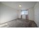 Bedroom with plush carpet, natural light, closet, and neutral paint at 4569 S Lowell Blvd # B, Denver, CO 80236
