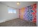 Bedroom boasting soft carpet, neutral paint and colorful accent wall at 4569 S Lowell Blvd # B, Denver, CO 80236