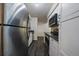 Galley kitchen featuring stainless steel appliances and white cabinetry at 4569 S Lowell Blvd # B, Denver, CO 80236