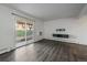 Bright living room features wood floors, fresh white paint, and sliding glass door at 4569 S Lowell Blvd # B, Denver, CO 80236