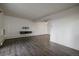 Bright living room features wood floors, fresh white paint, and a floating shelf at 4569 S Lowell Blvd # B, Denver, CO 80236