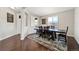 Bright dining room with a wooden table and chairs, hardwood floors and a rug at 26994 E Indore Ave, Aurora, CO 80016