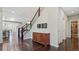 Elegant entryway with hardwood floors, a staircase, and a wooden console table at 26994 E Indore Ave, Aurora, CO 80016