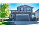 Two-story house with gray siding, stone accents, and a two-car garage at 26994 E Indore Ave, Aurora, CO 80016