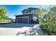 Two-story house with gray siding, stone accents, and a two-car garage at 26994 E Indore Ave, Aurora, CO 80016