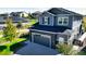 Two-story home with gray siding, stone accents, and a two-car garage at 26994 E Indore Ave, Aurora, CO 80016