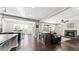 Open kitchen with an island, dark wood cabinets, and granite countertops at 26994 E Indore Ave, Aurora, CO 80016