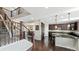 Modern kitchen with dark cabinets, granite countertops, and island at 26994 E Indore Ave, Aurora, CO 80016