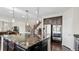 Modern kitchen with dark wood cabinets, granite countertops, and a large island at 26994 E Indore Ave, Aurora, CO 80016