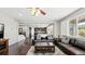 Spacious living room featuring a leather couch and a view into the kitchen at 26994 E Indore Ave, Aurora, CO 80016
